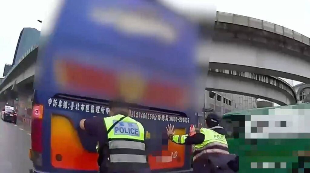 見遊覽車拋錨,員警立即下車協助推車至空曠處,恢復車流順暢。(圖/記者薛秀蓮翻攝)