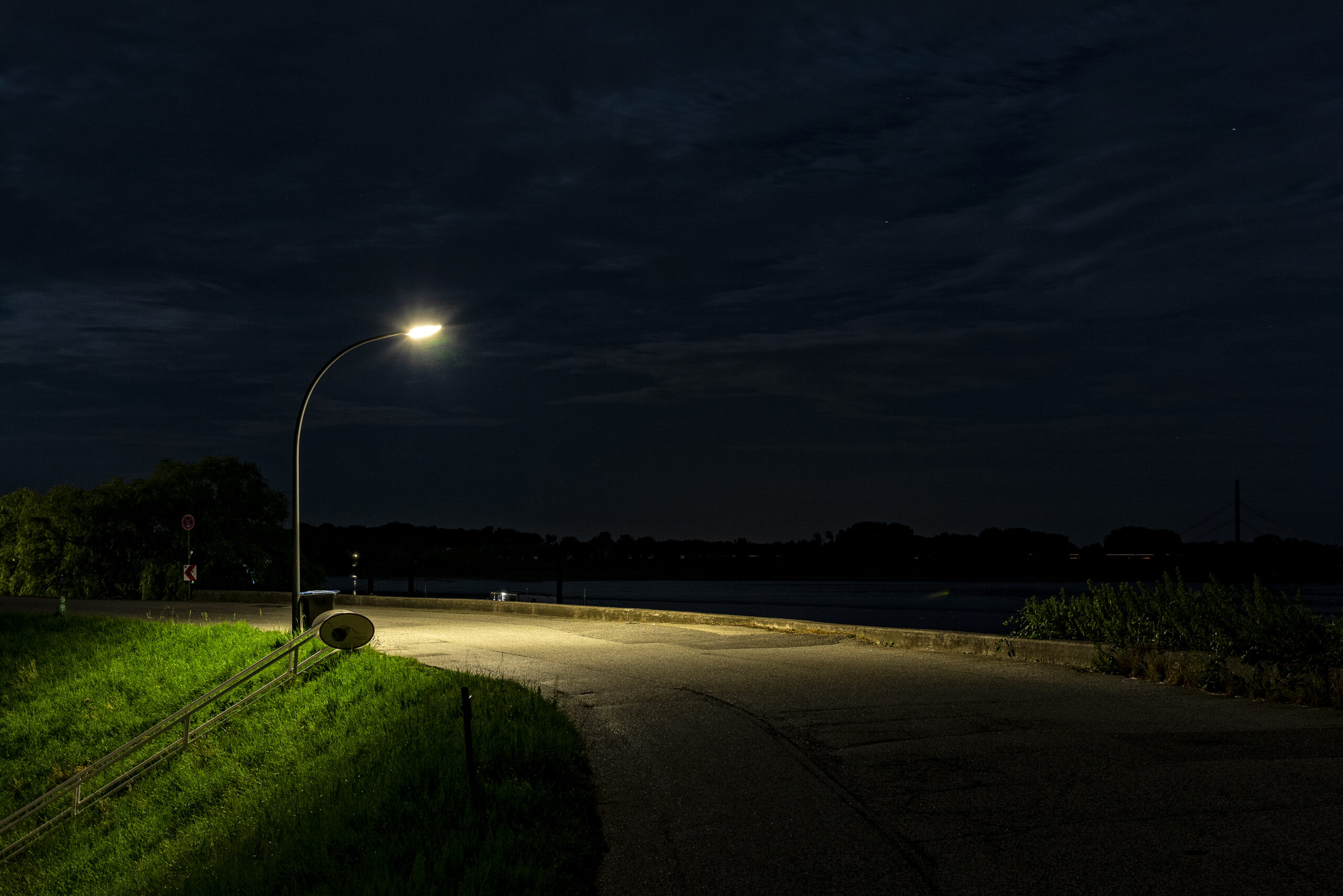 illuminated street light by road night scaled