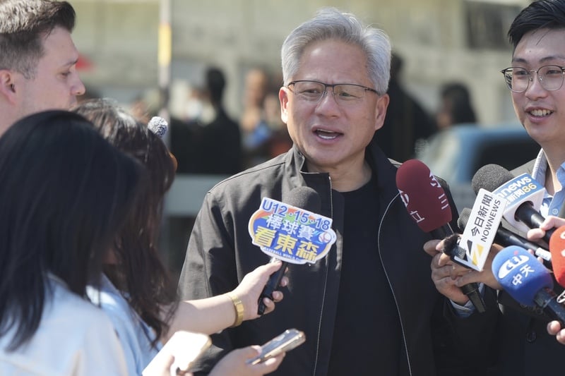 輝達（NVIDIA）執行長黃仁勳（中）22日上午再度到訪台灣，他在松山機場接受媒體訪問時表示，將與台積電高層會面。中央社