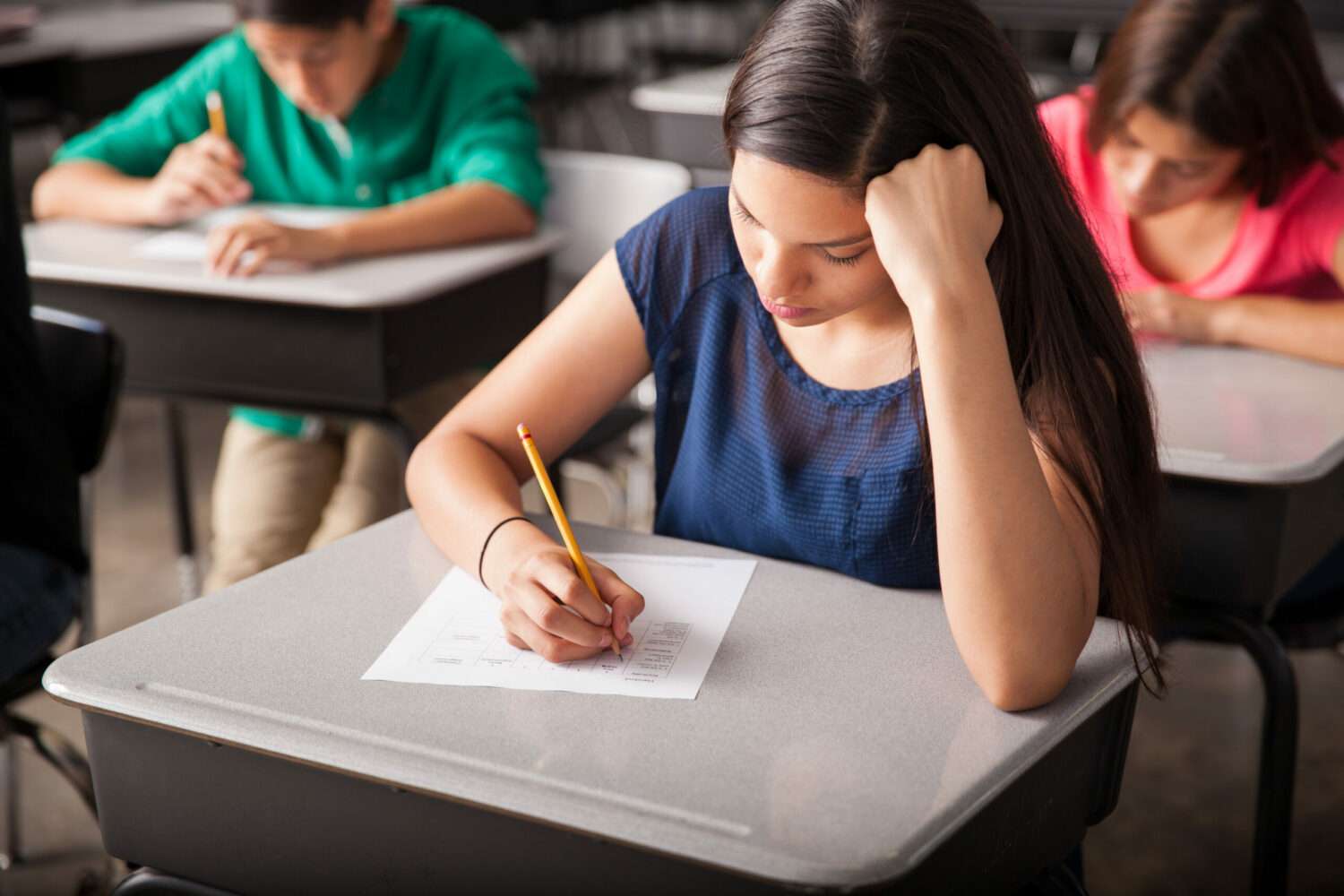 group high school students taking test classroom scaled e1705464175864