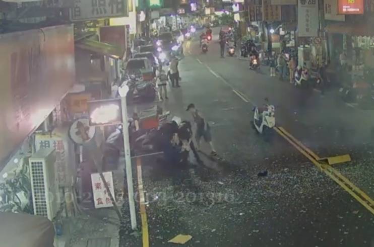 警員黃敏敏跟林德龍,二人一起拉二名受傷民眾離開現場。(記者李健興翻攝)