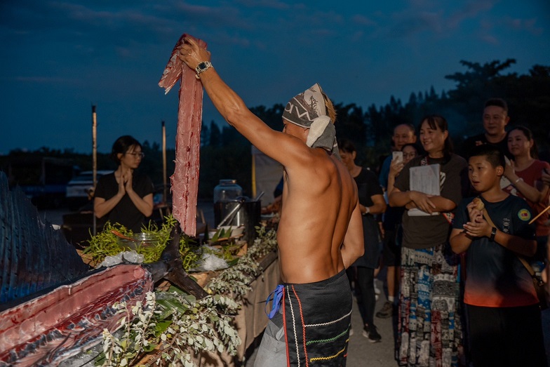 ▲靜浦部落青年主廚里艾精彩上演殺魚秀，展示海岸阿美飲食文化。