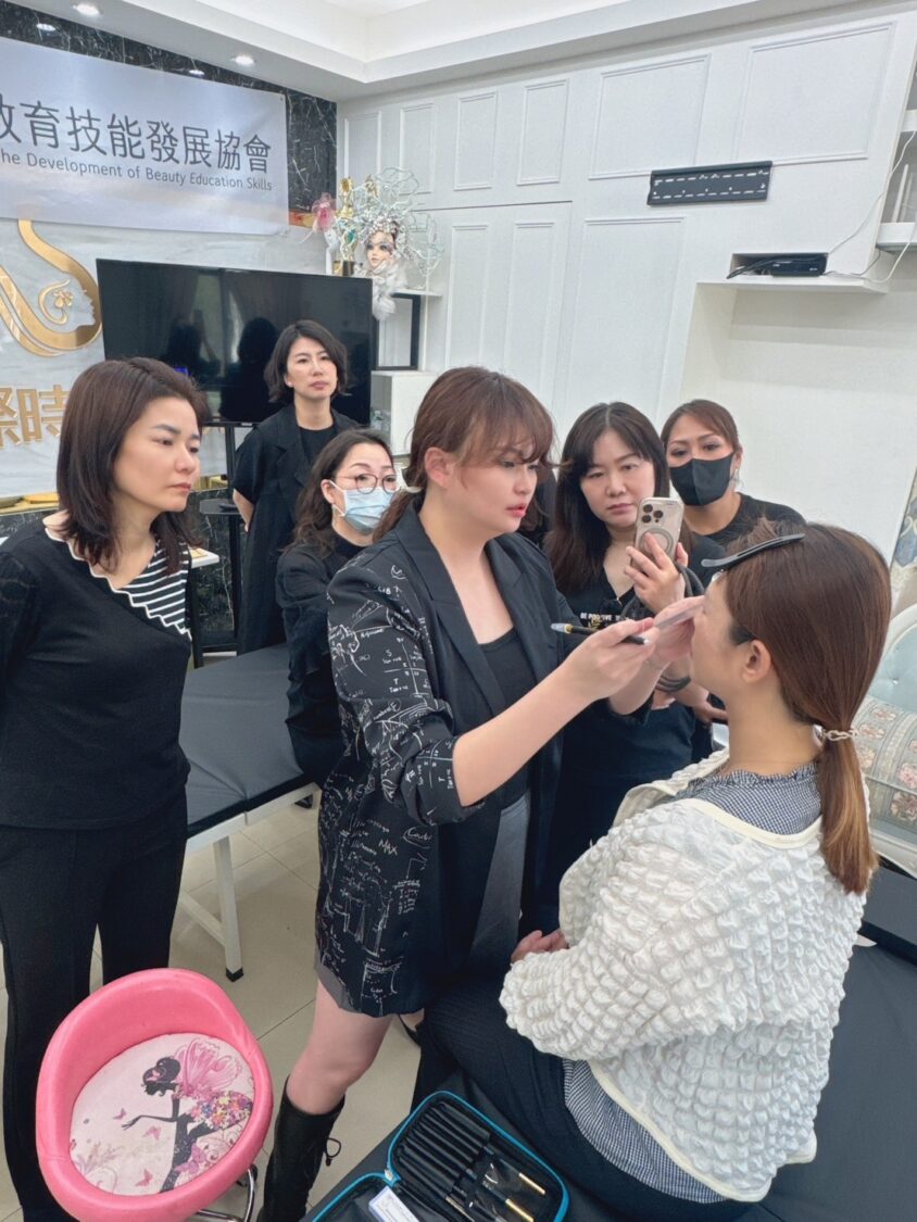李孟蒖老師(中)於中華國際美業教育技能發展協會授課現場示範紋繡操作,透過專業實作與個別指導,提升學員專業技巧與作品美感。(圖/李孟蒖提供)