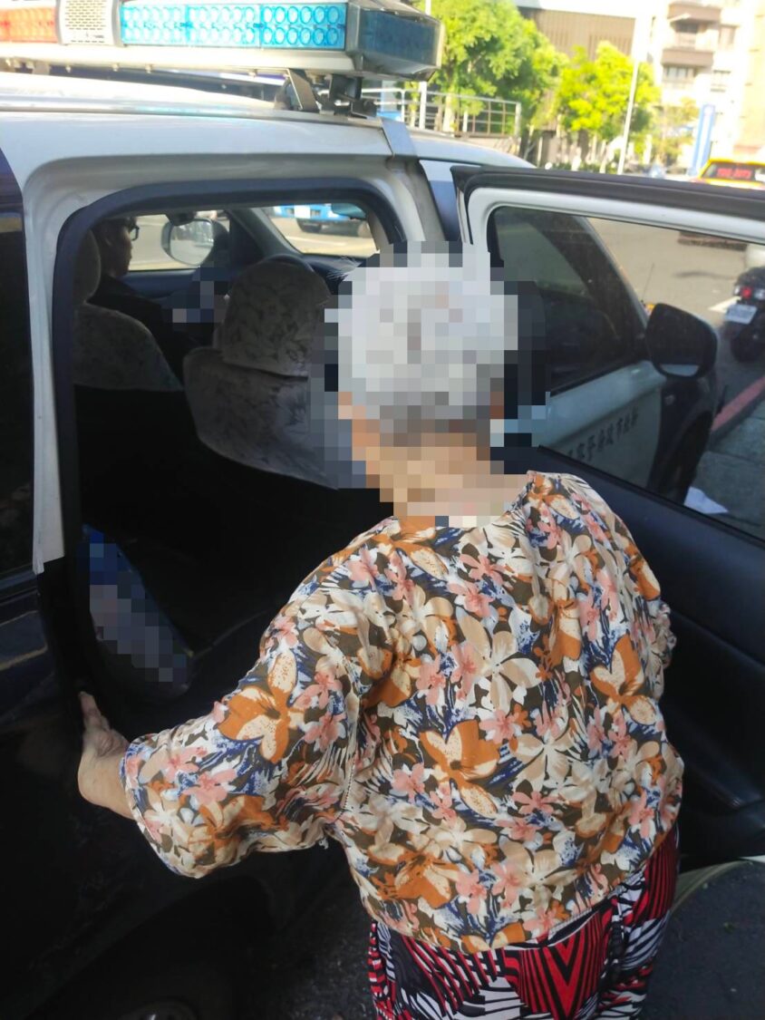 員警護送民眾上警車返家。(記者李健興翻攝)