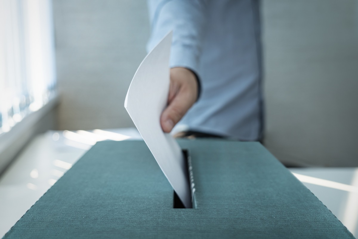 hand holding ballot paper election vote concept man votes election referendum