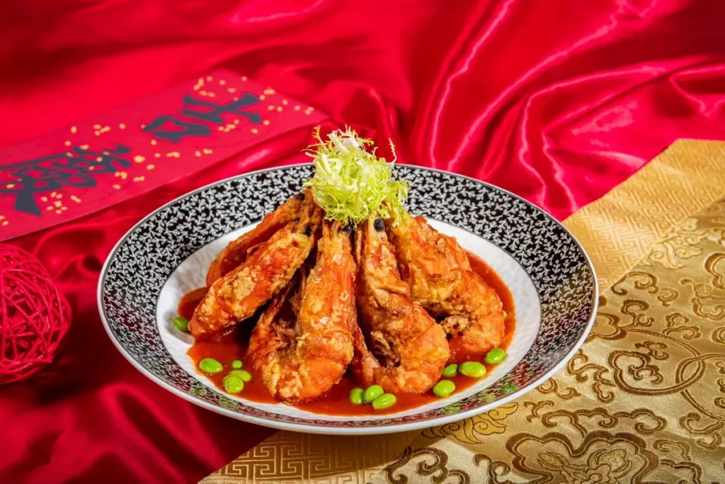 台北凱達大飯店今年新推出的「蒜香茄汁軟殼蝦」,以外殼酥香、肉質鮮嫩的軟殼蝦加入蒜香爆炒與特製茄汁煨煮,酸甜茄香與蒜香完美融合,口感鮮甜不膩。圖:台北凱達大飯店提供