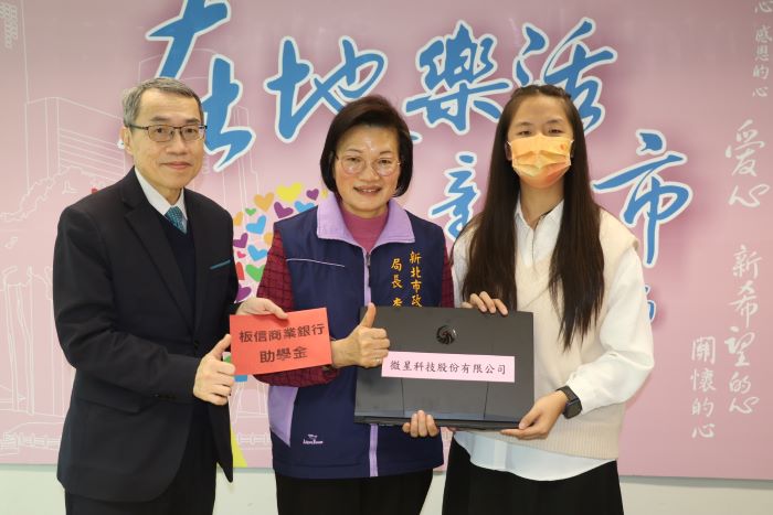 安置兒少自立向學明燈 小亭錄取臺大翻轉人生 40 《圖說》板信銀行副總經理黃家泰(左)捐贈助學金,李美珍局長代表微星科技捐贈筆電給小亭。〈社會局提供〉