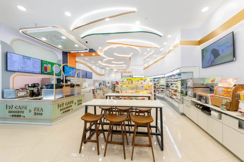 7-ELEVEN愿秀門市內部天花板以「歡慶」的氛圍做為設計概念,增添橘色與綠色的彩帶及牆面的流線燈帶,猶如交織在空中的璀璨煙火綻放