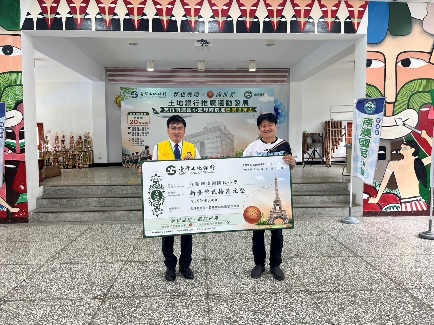 土地銀行個人金融部經理陳百泰（左）代表致贈公益基金款項予南澳國小校長林光章（右），支持南澳國小籃球隊參加「2026 法國巴黎世界盃國際籃球分齡錦標賽。（圖／記者 劉其昌翻攝）