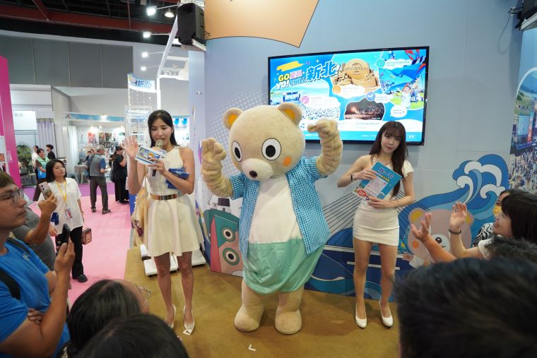 台北國際夏季旅展開跑 新北館抽獎加碼搶攻暑期商機 50 《圖說》新北市觀光吉祥物「小客」歡樂現身,與主持人共同帶動現場熱烈氣氛,吸引民眾熱情參與互動。〈觀旅局提供〉