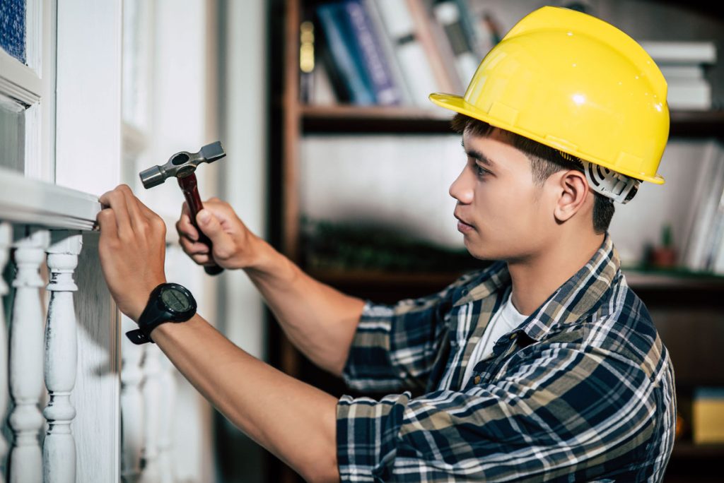 Carpenter Holds Hammer Nails