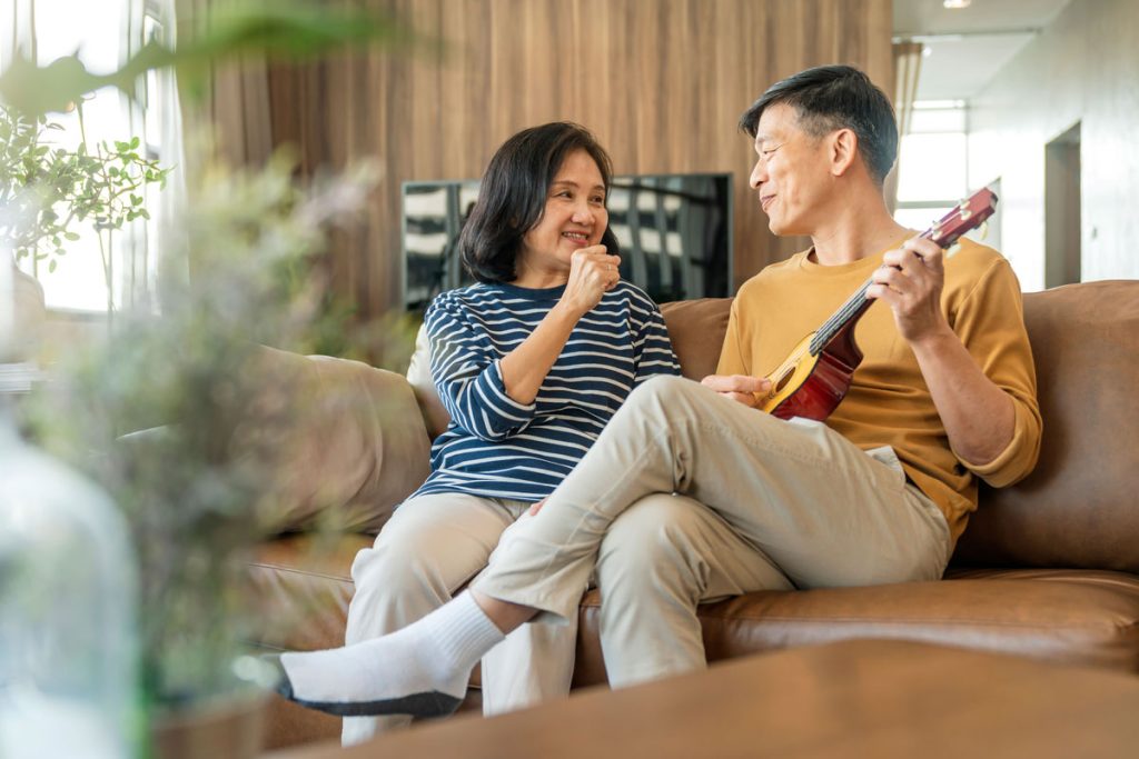 Sweet Asian Senior Couple Sing Play Acoustic Ukulele Instrument Happy Smiling Elderly Grandparent Having Fun Enjoying Their Retirement Life Lifestyle Party Happy Lifestyle